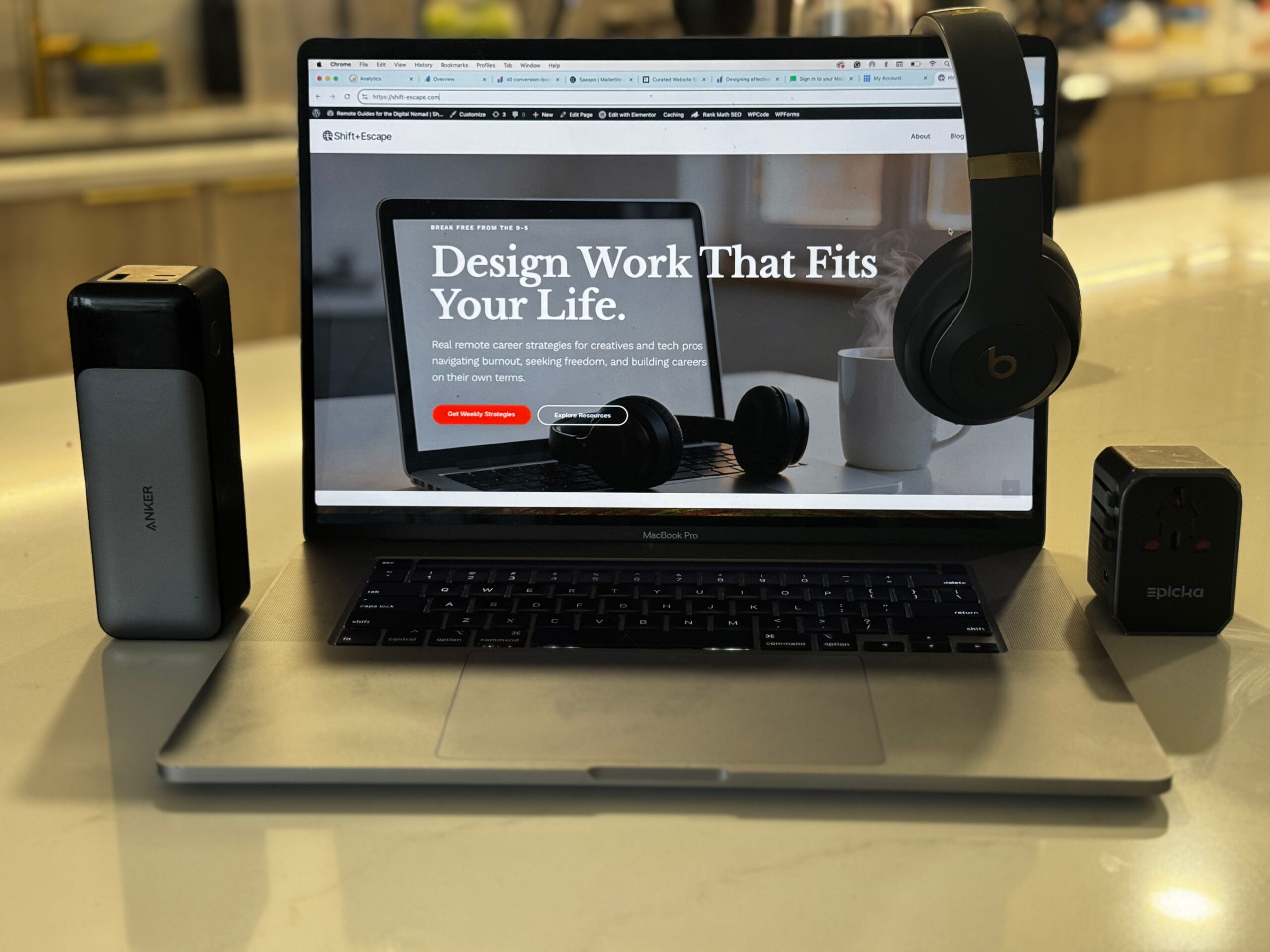 Digital nomad tech stack workspace setup MacBook Pro Anker power bank Beats headphones remote work gear